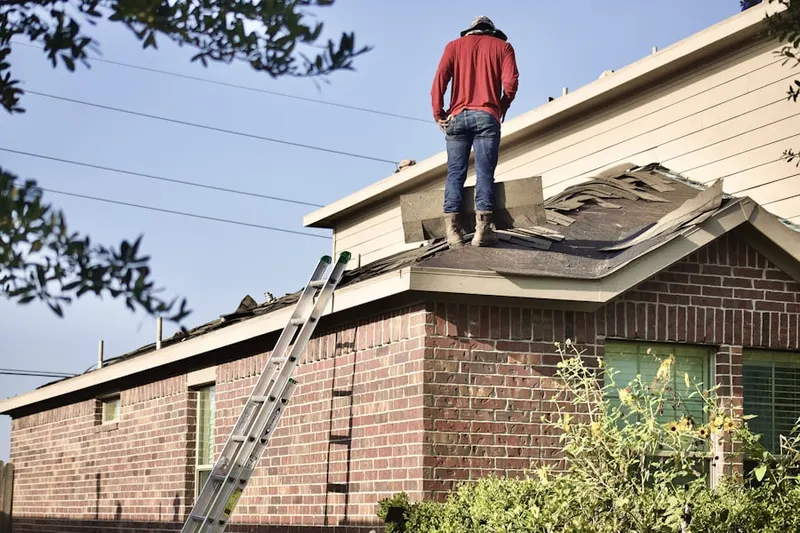 Professional roofer working on a residential roof in Willow Crest